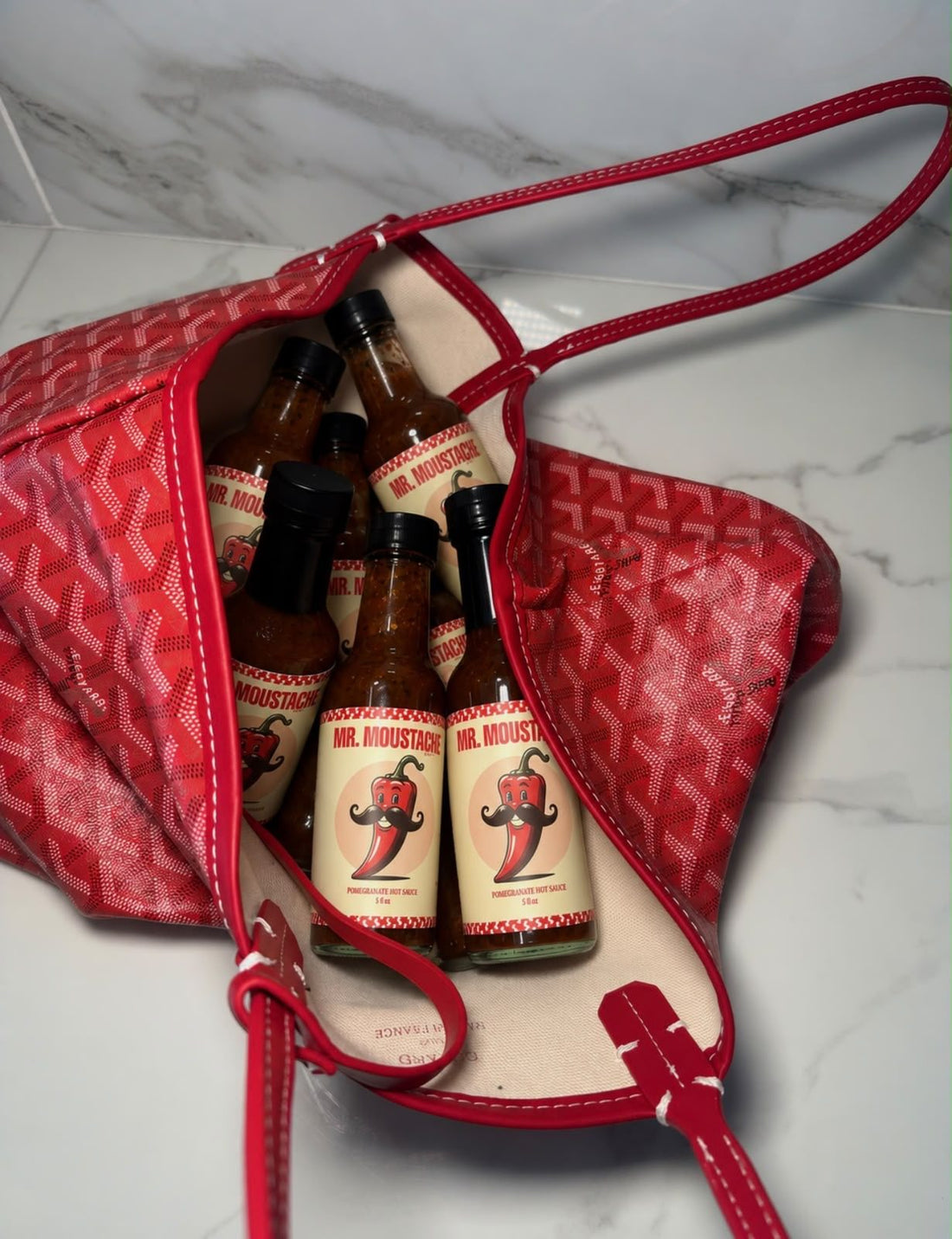 A tote bag full of Mr. Moustache bottles